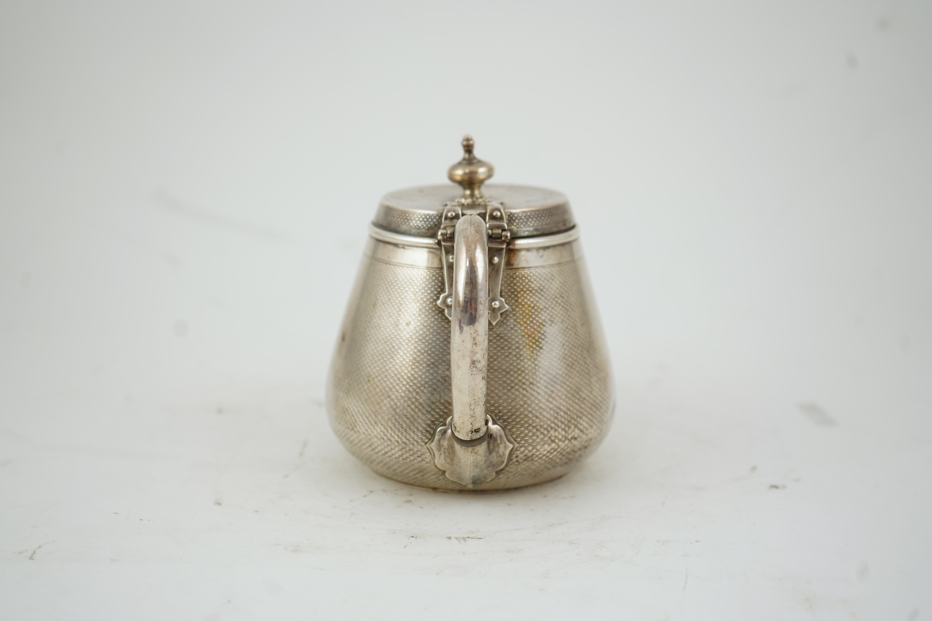 A Victorian engine turned silver teapot by Hunt & Roskell